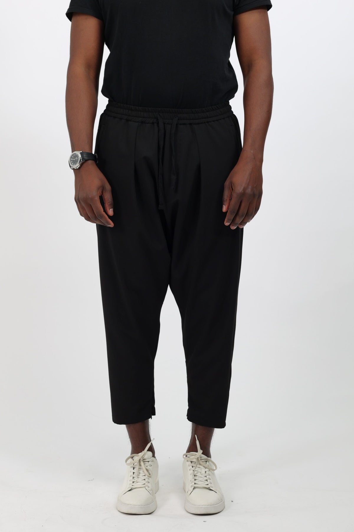 Sarouel homme sport chic noir porté de face, baskets blanches